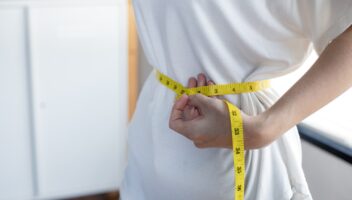 Woman with perfect waist with measuring tape.